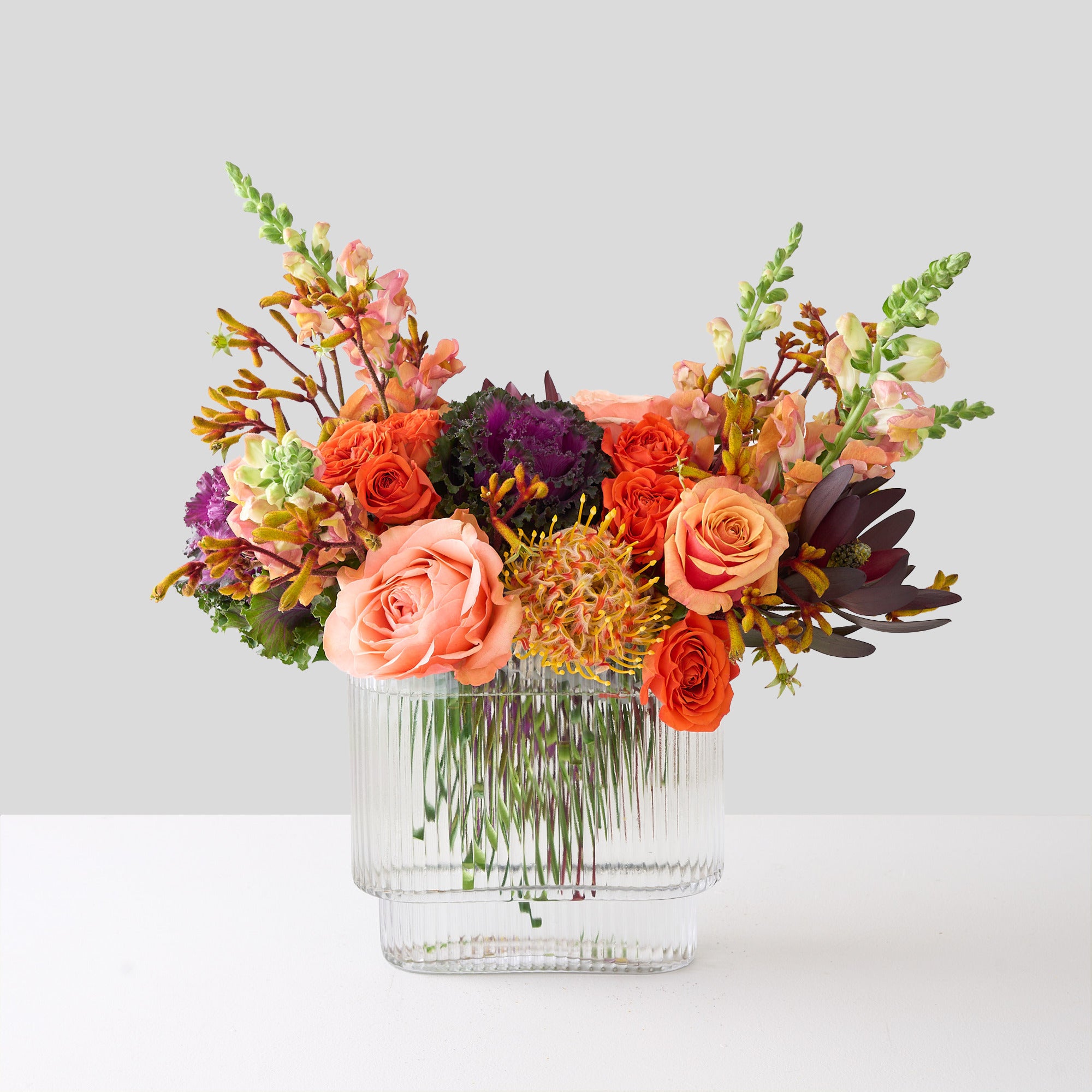 halloween flower arrangement with orange flowers, purple cabage, kangaroo paws and protea