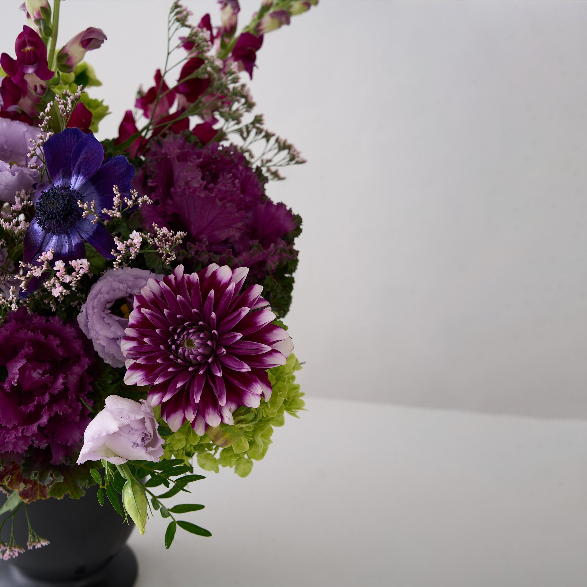 Bouquet of purple and green flowers on a white background