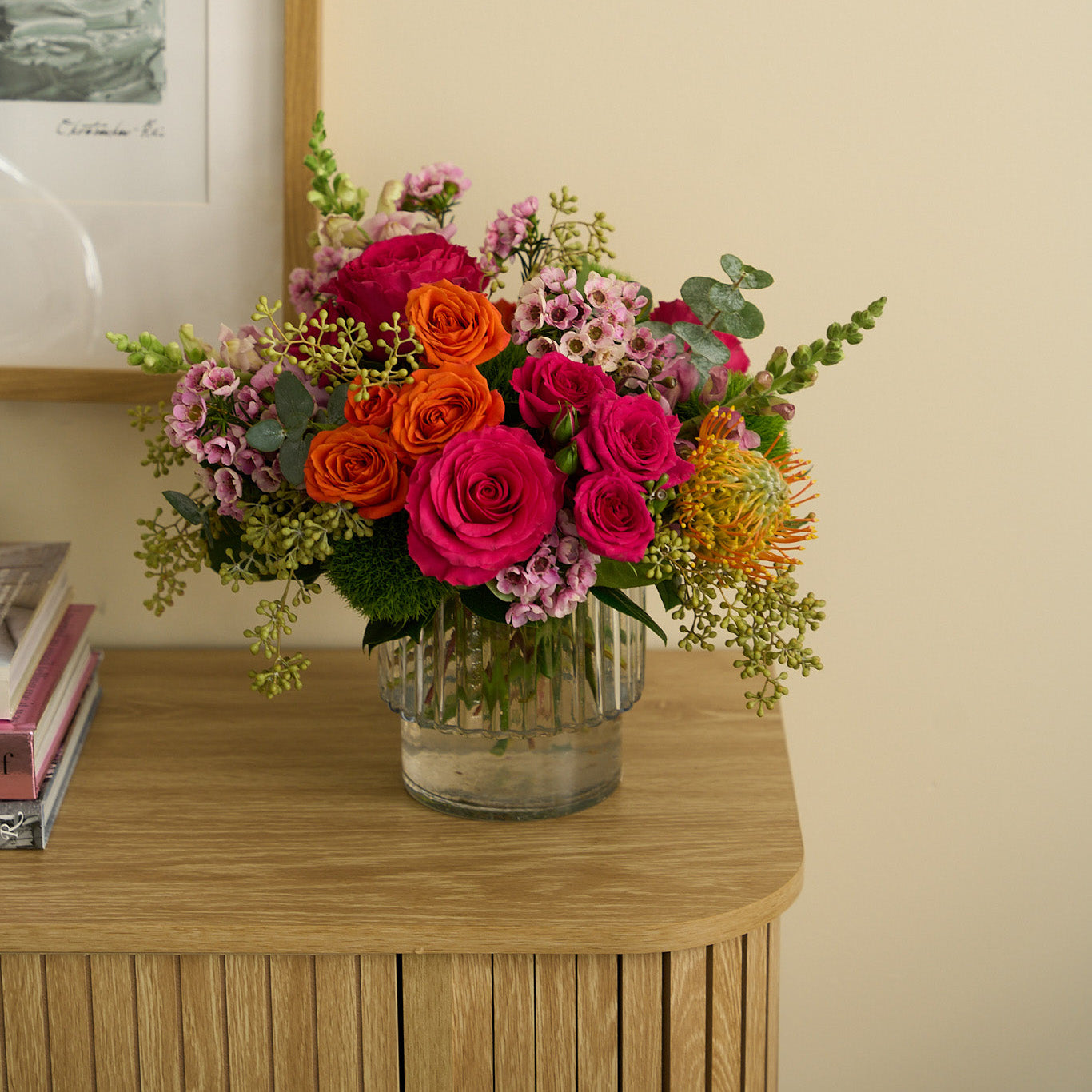 Talia arrangement of colorful Easter flowers on credenza
