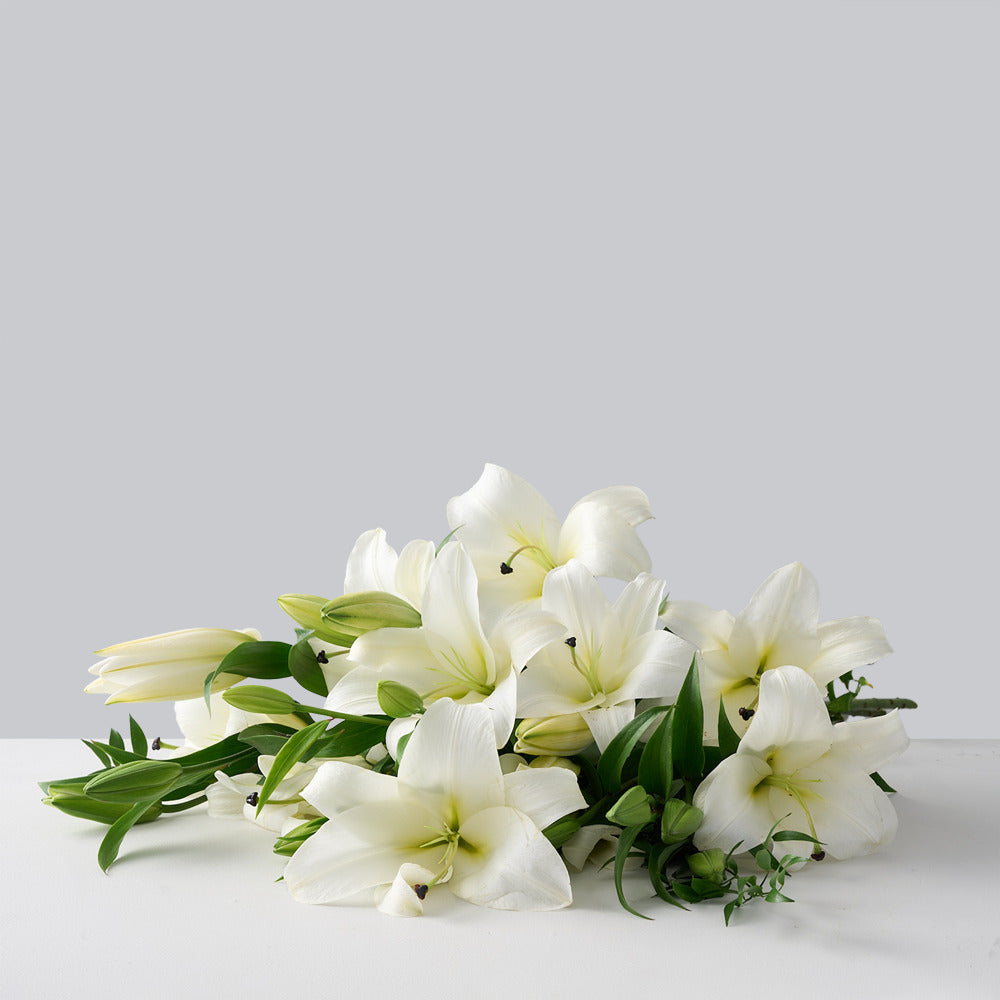 White lilies with ruscus