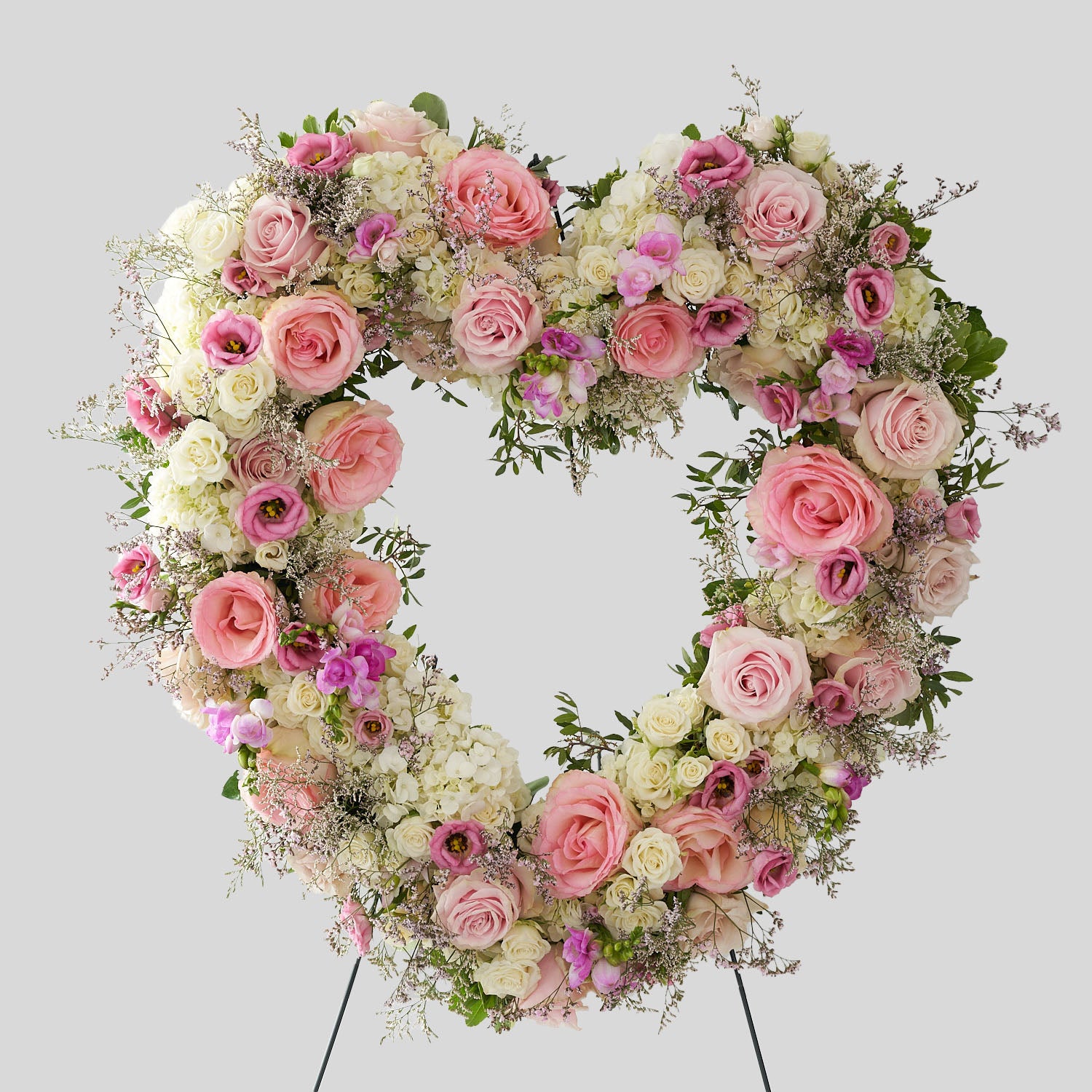 A colourful arrangement of pink and white roses, lisianthus, hydrangeas as well as other greens