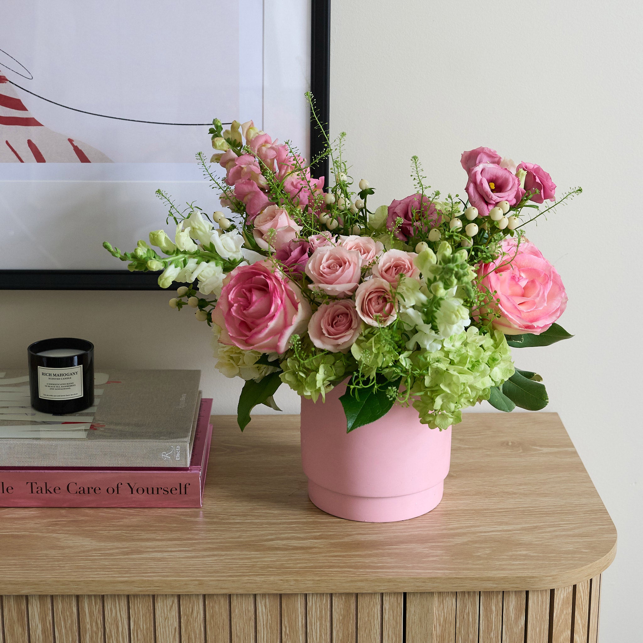 pink vase with pink, green and white flowers