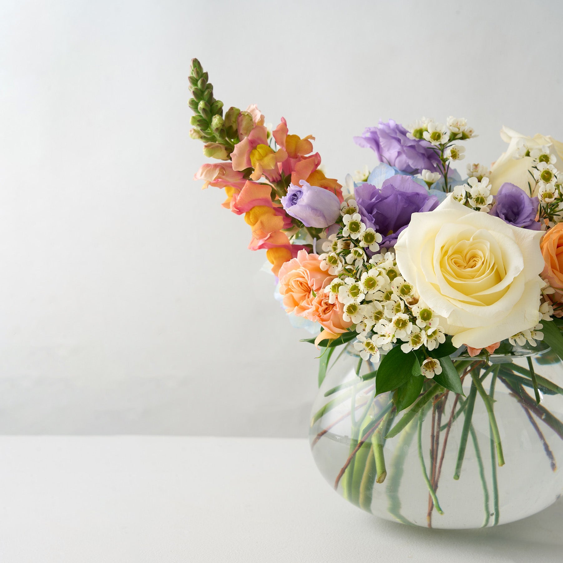 Easter flower arrangement in a white vase on a light background