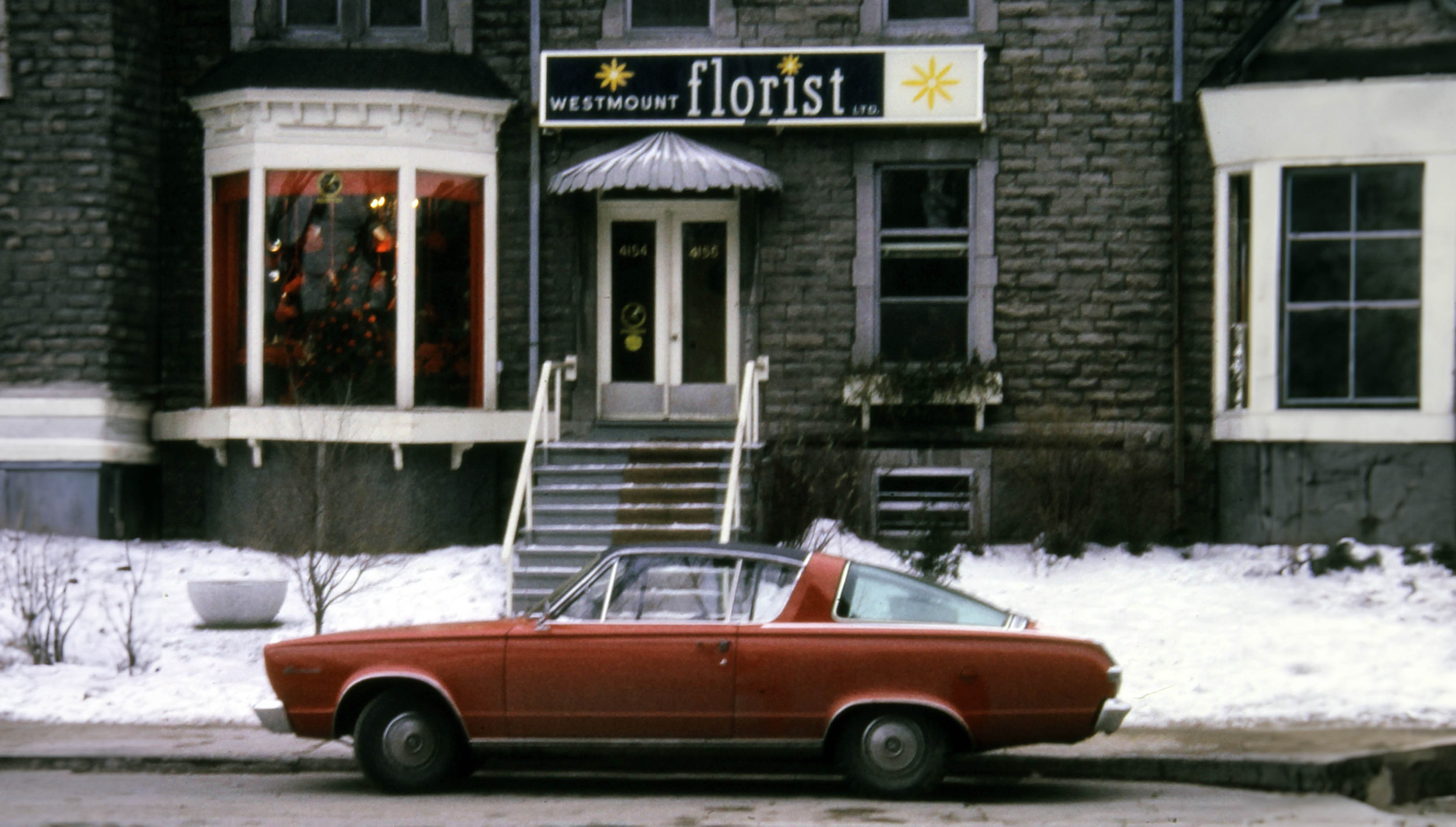 Old photo of vintage car parked in front of Westmount florist - 1960