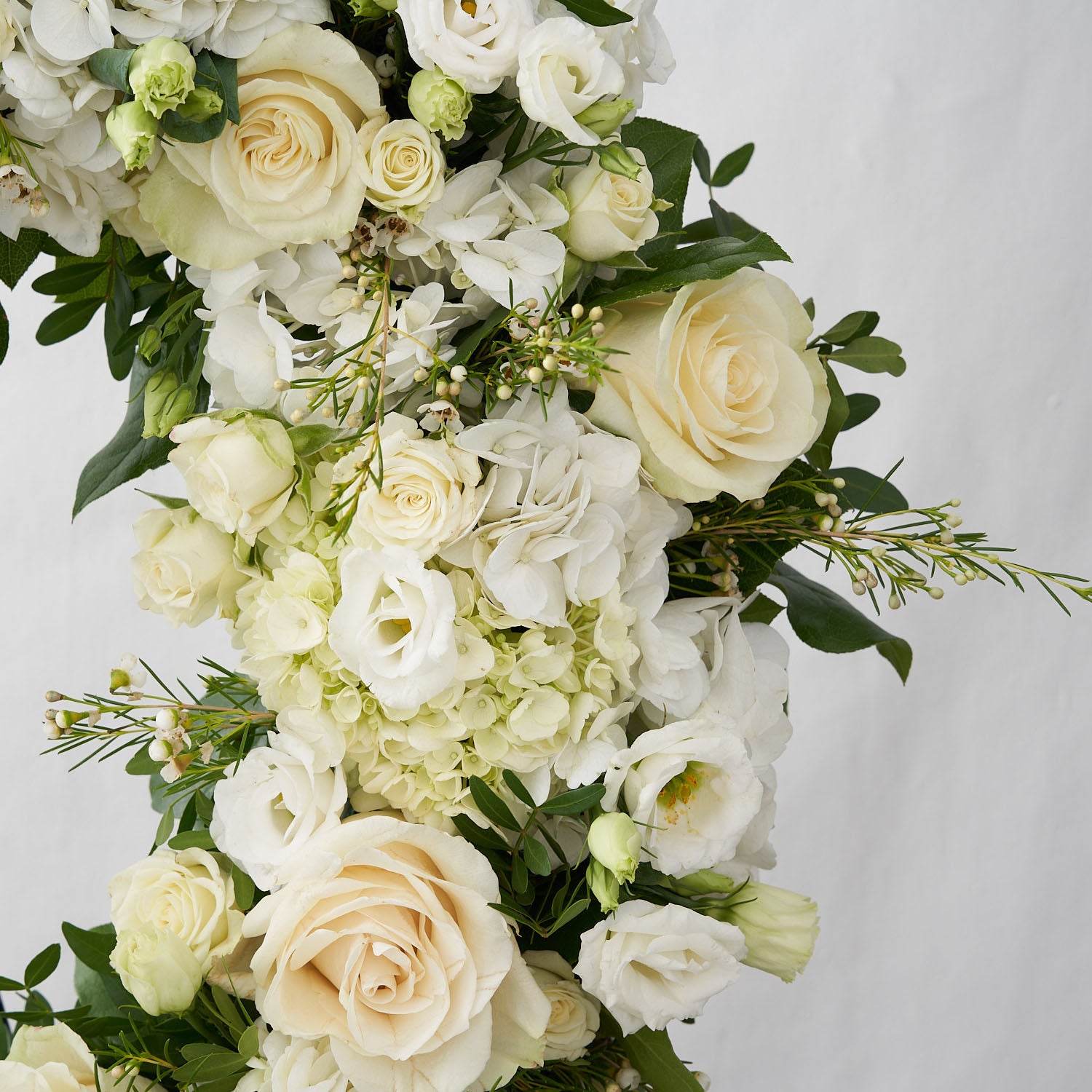 White mondial roses, white anemones, white hydrangea and other greenery