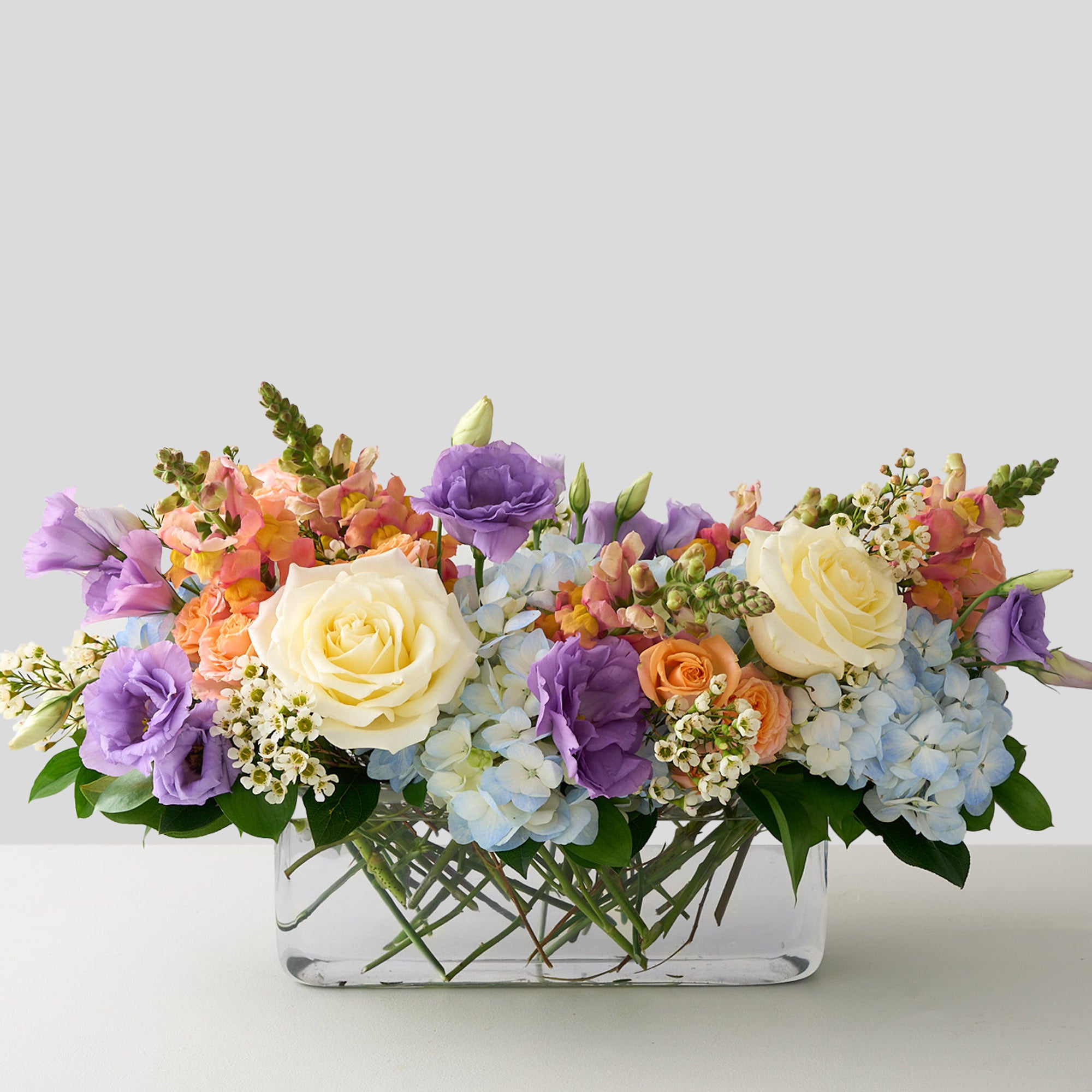 Colorful Easter flower centerpiece arrangement in a clear vase 