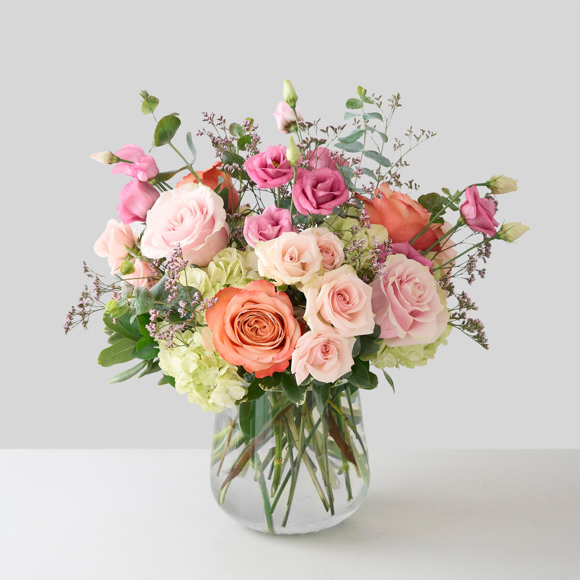 mother's day arrangement with pink and coral roses, rose lisianthus; and white hydrangea.