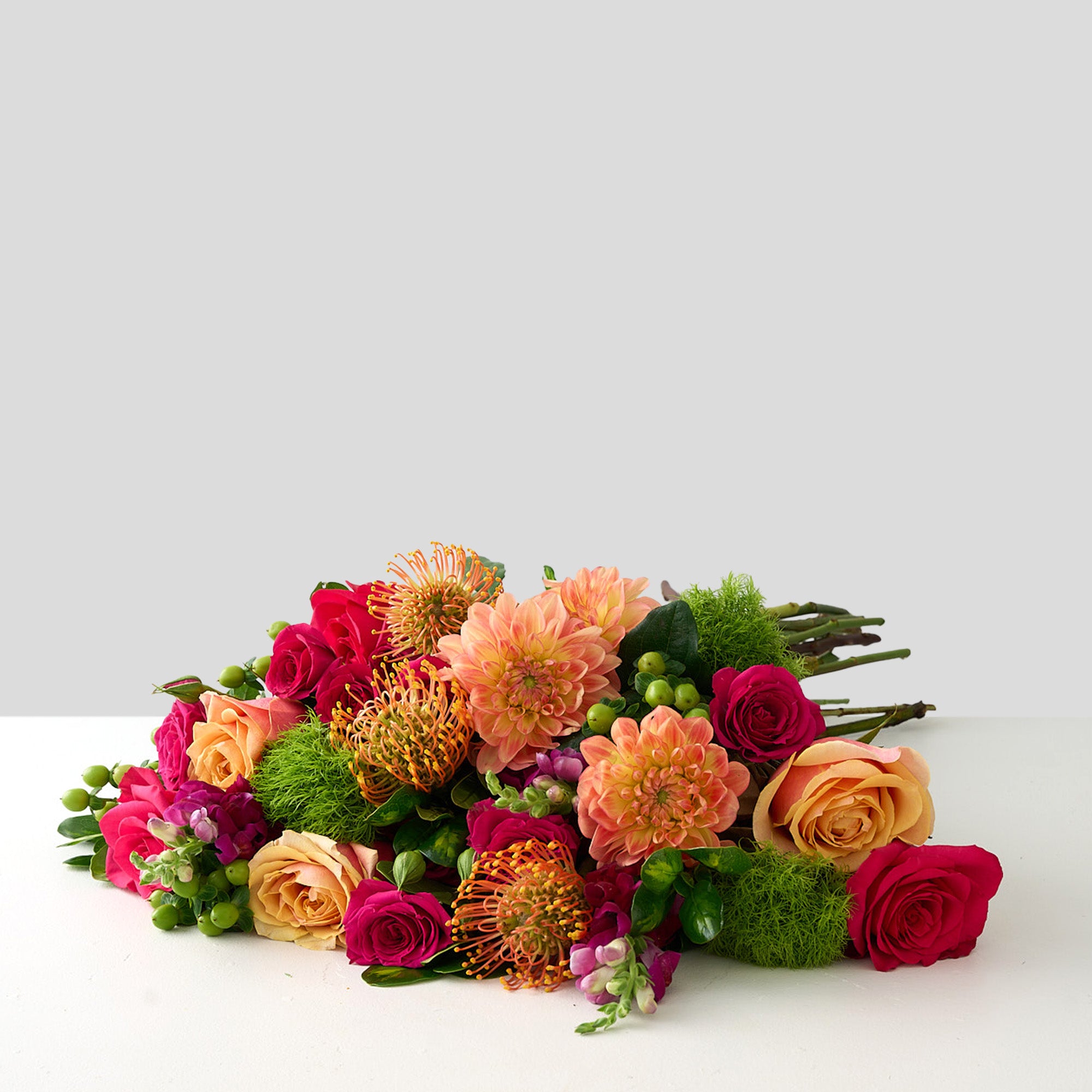 bouquet of coral dahlias, fuchsia roses, green mums and hypericum and peach roses