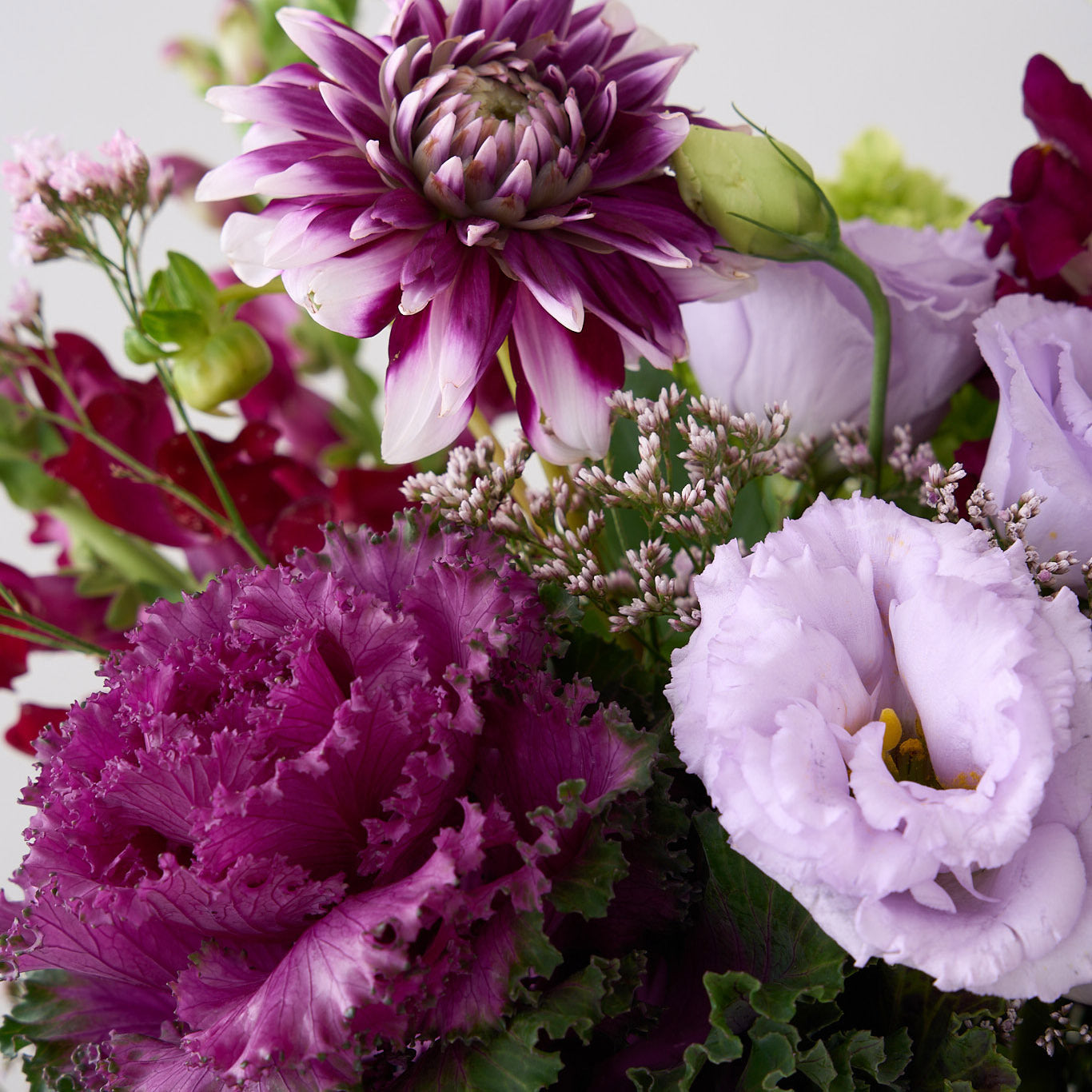 Close up of Sabrina Halloween arrangement showing purple cabbage, dahlia flowers with lavender Lisianthus