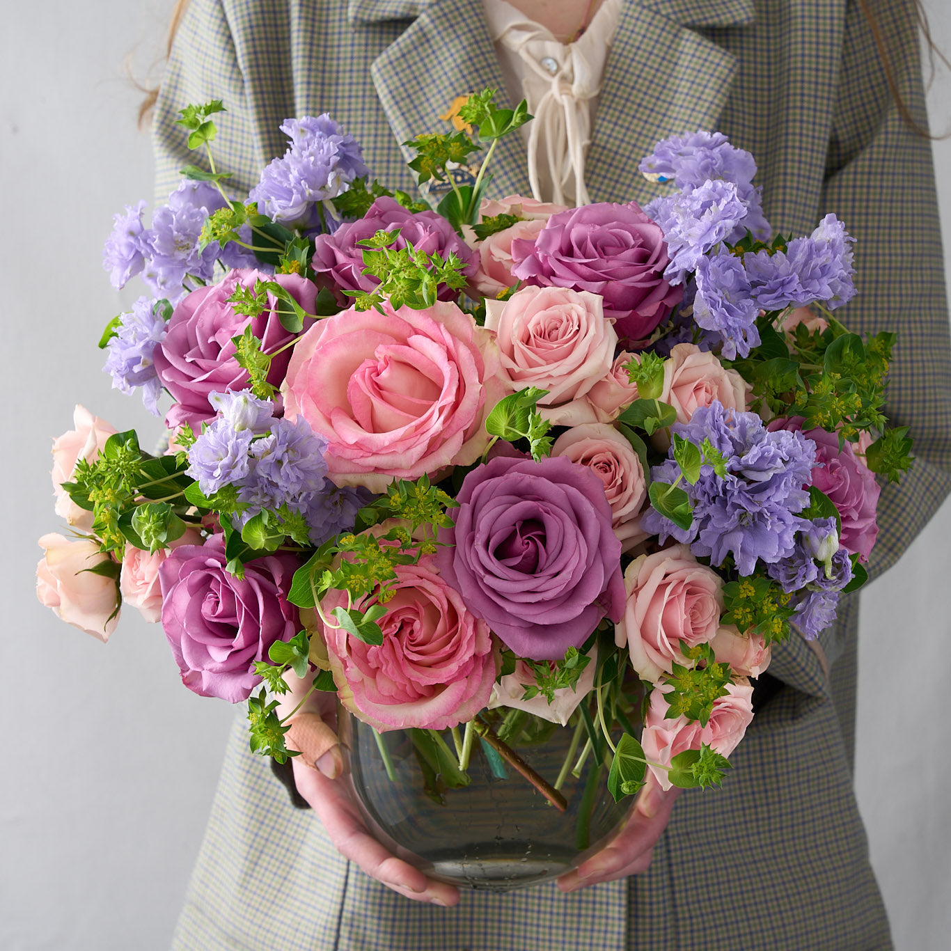 soft pink spray roses, green Bupleurum, lavender delphinium, Piacere roses, and Esperance  Arranged in a round-bottom vase