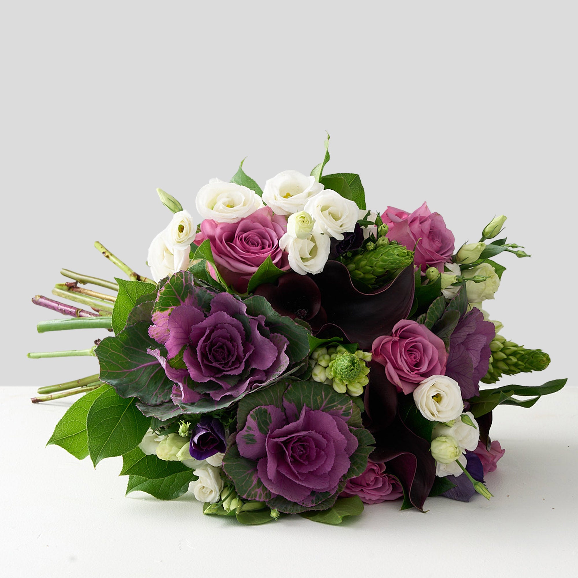 picture of bouquet of purple cabbage stems, lisianthus, mauve piacere roses, and white Bethlehem stars