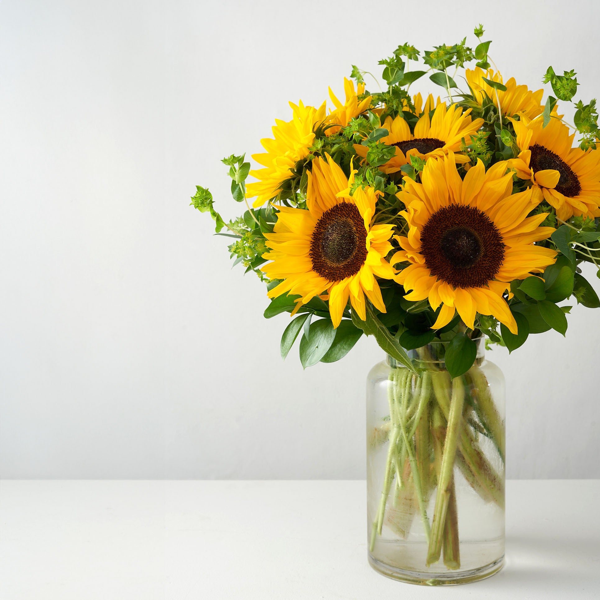 Sunflowers arranged in a clear glass vase